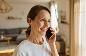 Woman on the phone at home checking her urgent care insurance coverage