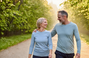 Middle-aged couple on a morning walk near Covington as part of a healthy preventive care routine