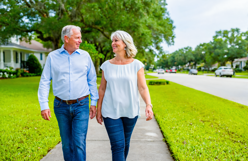 Older couple walking outdoors in a St. Tammany Parish neighborhood, staying active with ongoing primary care