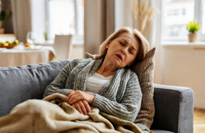 Older woman resting on her sofa at home with RSV and cold symptoms near Covington LA